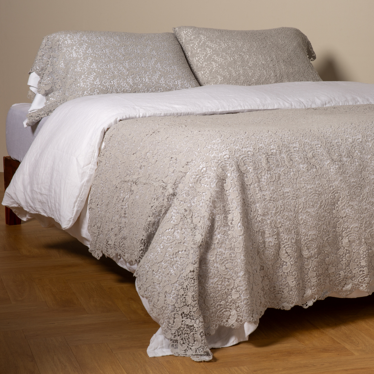 Cloud: cotton lace bed scarf draped across the foot of a bed dressed in linen sheets and duvet cover in winter white -  shown with matching lace pillowcase covers over a linen liner in winter white. 