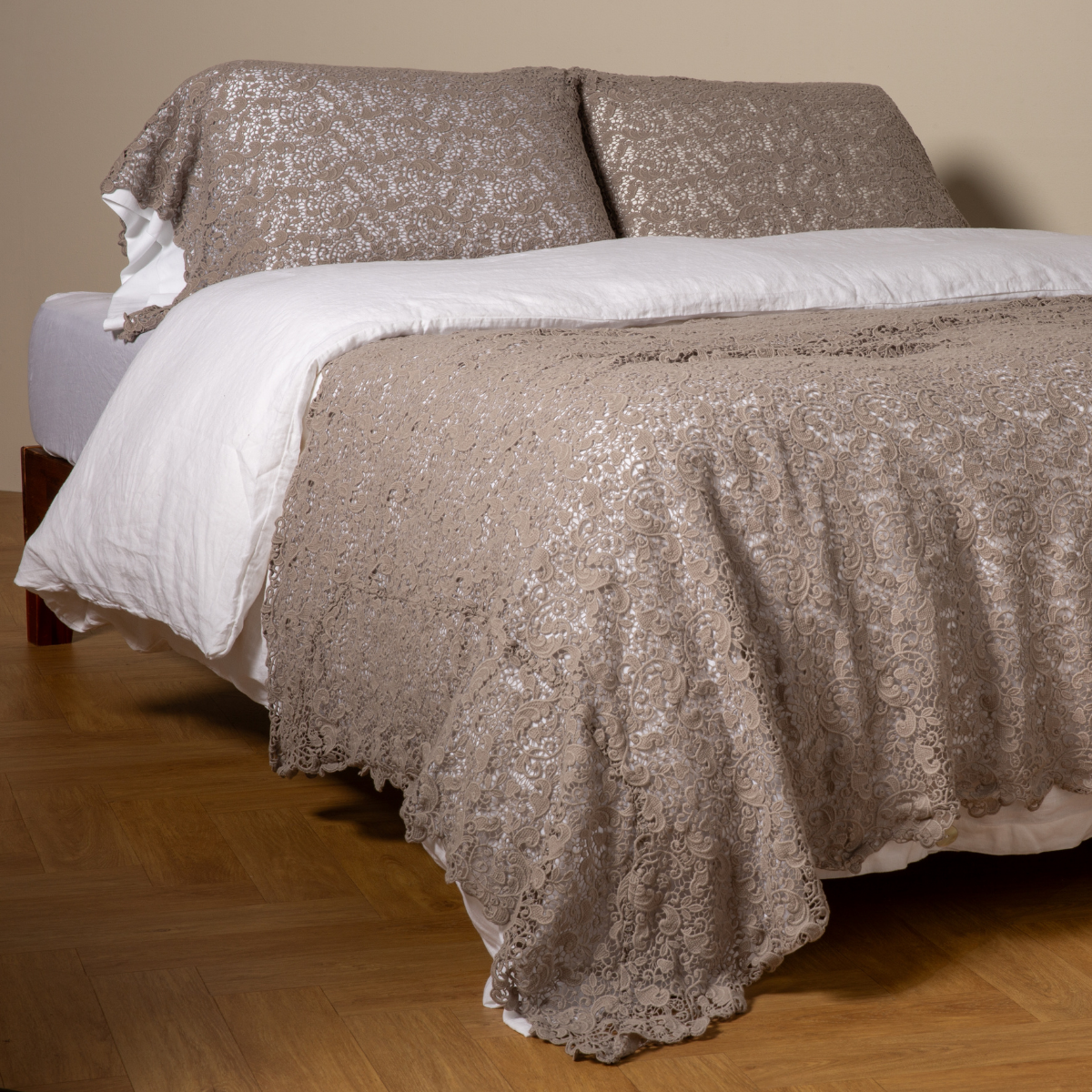 Fog: cotton lace bed scarf draped across the foot of a bed dressed in linen sheets and duvet cover in winter white -  shown with matching lace pillowcase covers over a linen liner in winter white. 