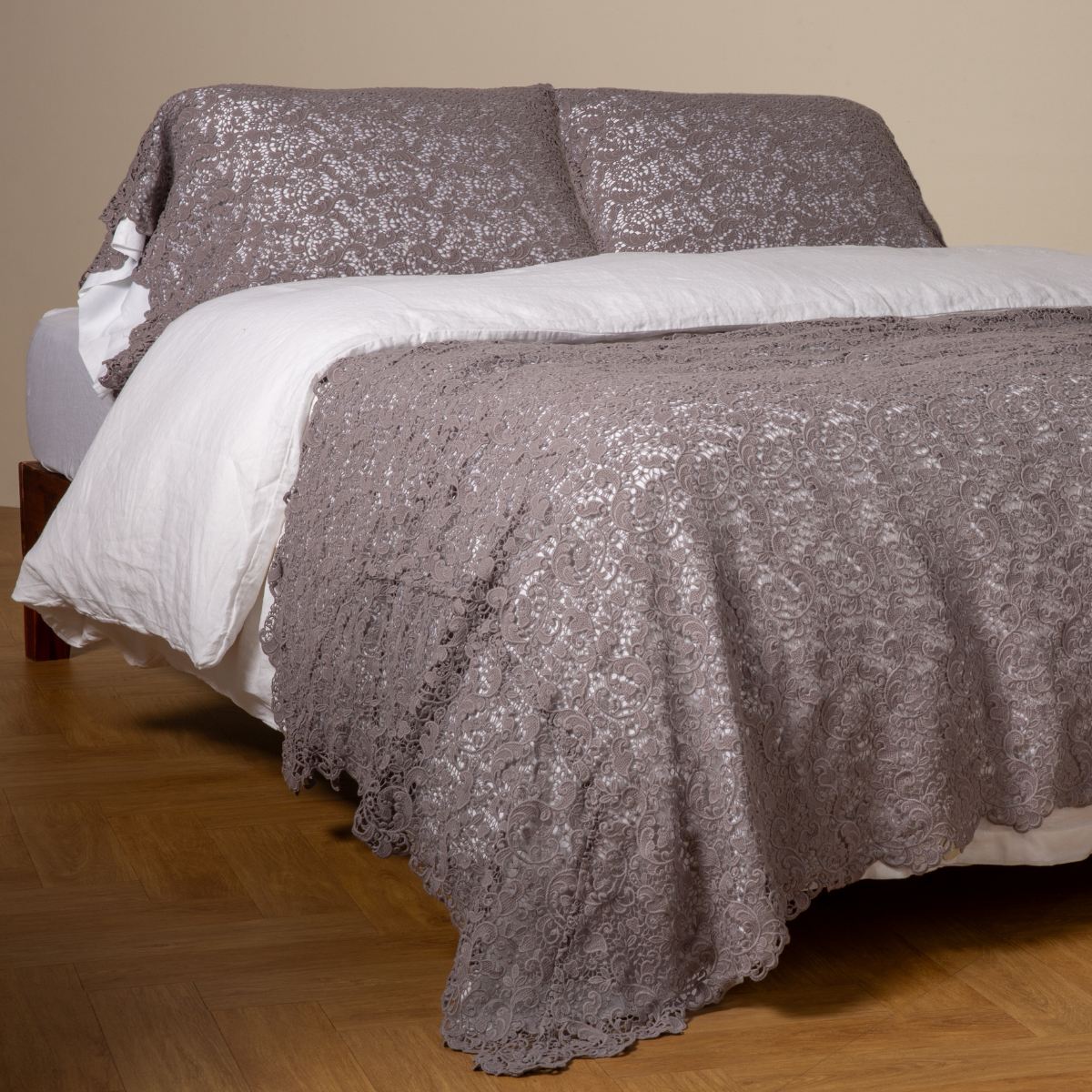 French Lavender: cotton lace bed scarf draped across the foot of a bed dressed in linen sheets and duvet cover in winter white -  shown with matching lace pillowcase covers over a linen liner in winter white. 