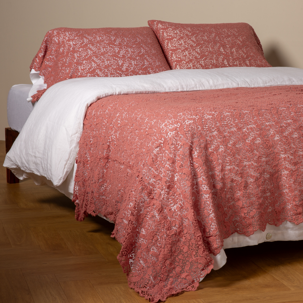 Poppy: cotton lace bed scarf draped across the foot of a bed dressed in linen sheets and duvet cover in winter white -  shown with matching lace pillowcase covers over a linen liner in winter white. 