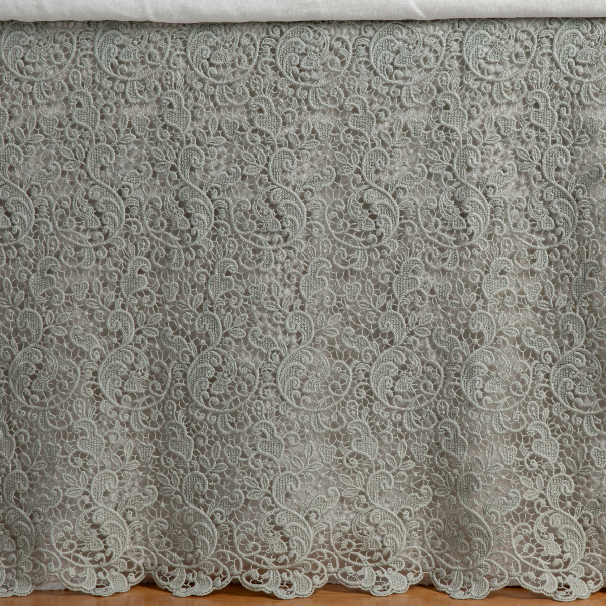 Eucalyptus: a close up of a cotton lace bed skirt layered over a winter white bed skirt - shot straight at the bed skirt. 