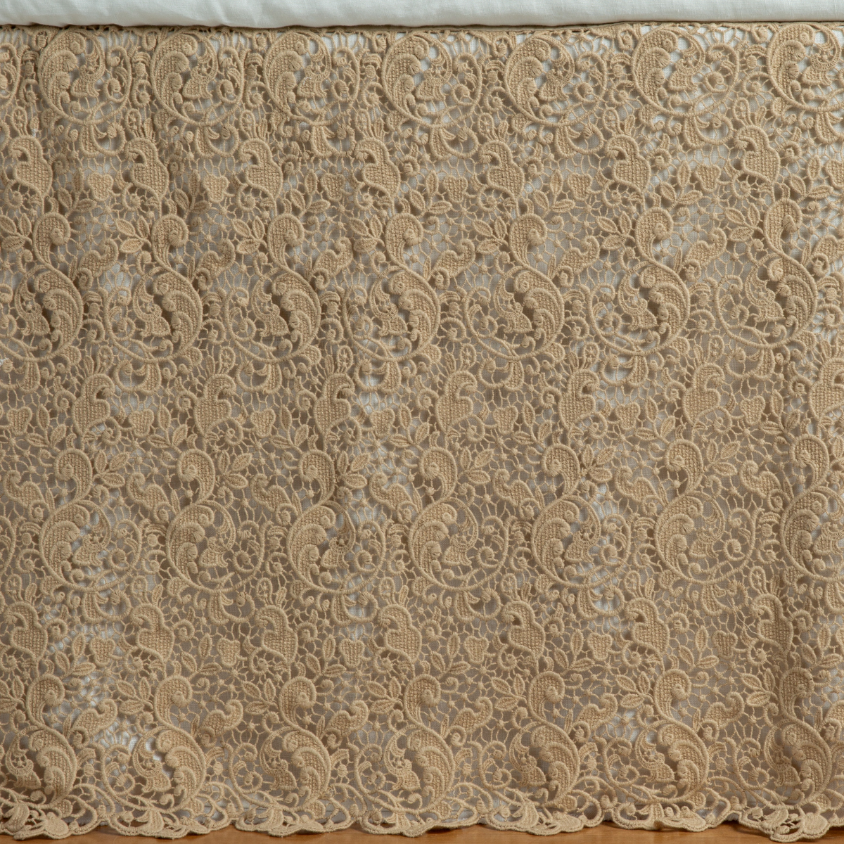 Honeycomb: a close up of a cotton lace bed skirt layered over a winter white bed skirt - shot straight at the bed skirt. 