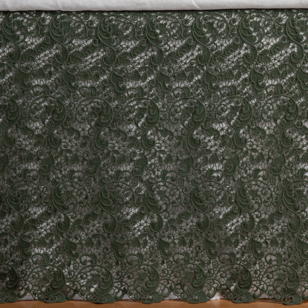 Juniper: a close up of a cotton lace bed skirt layered over a winter white bed skirt - shot straight at the bed skirt. 