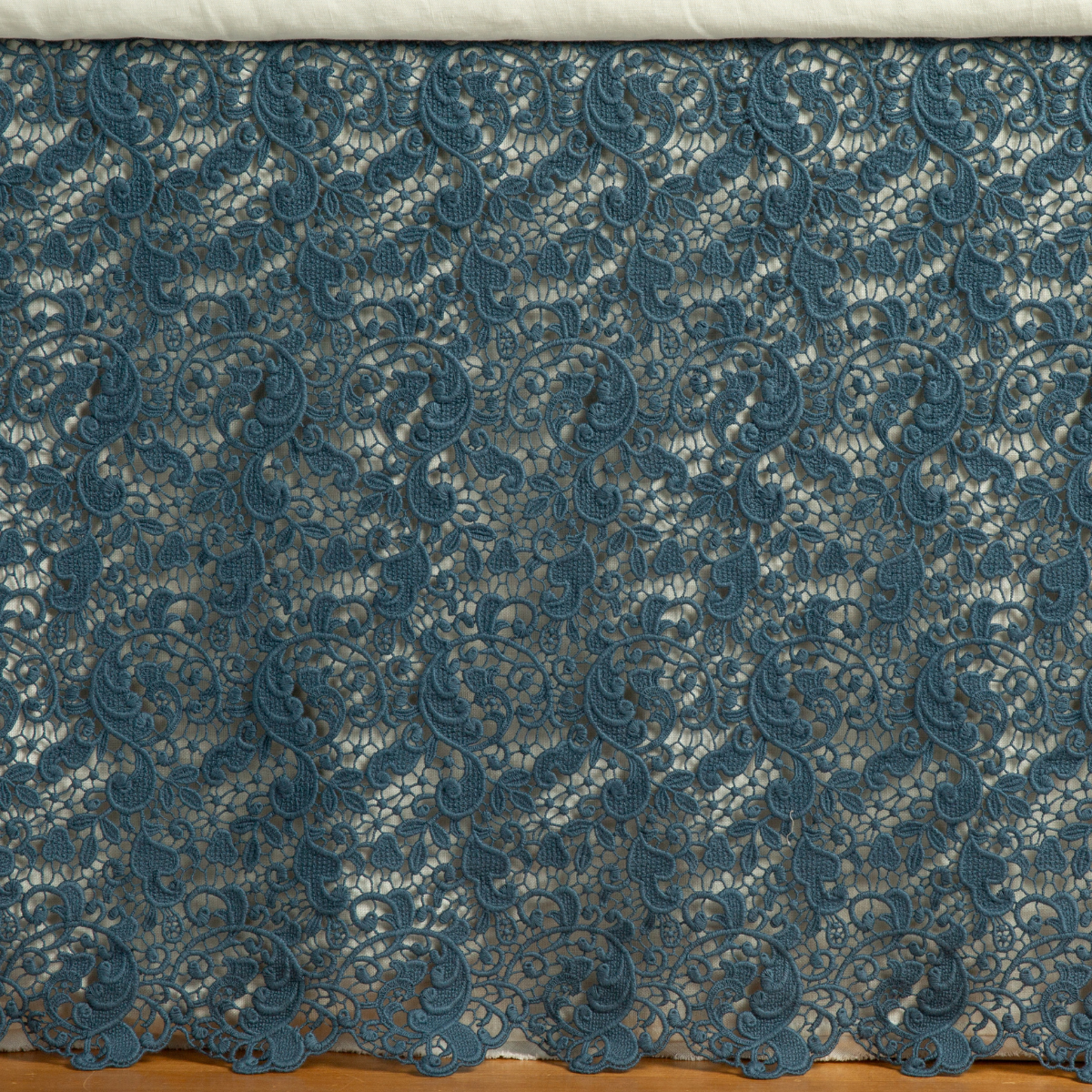 Midnight: a close up of a cotton lace bed skirt layered over a winter white bed skirt - shot straight at the bed skirt. 