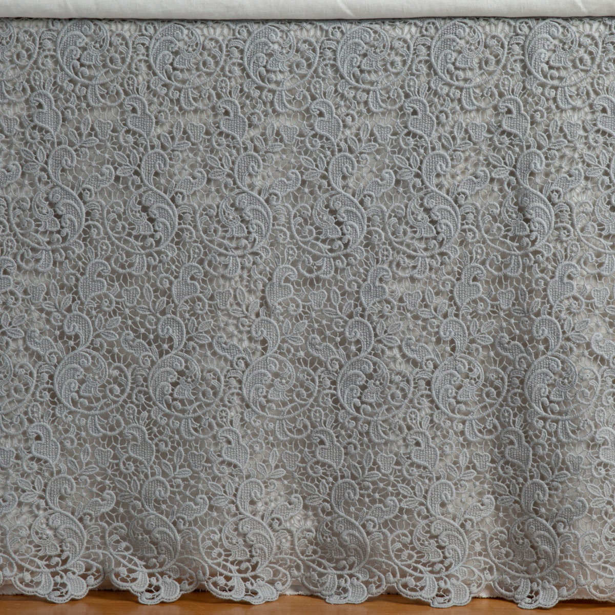 Mineral: a close up of a cotton lace bed skirt layered over a winter white bed skirt - shot straight at the bed skirt. 