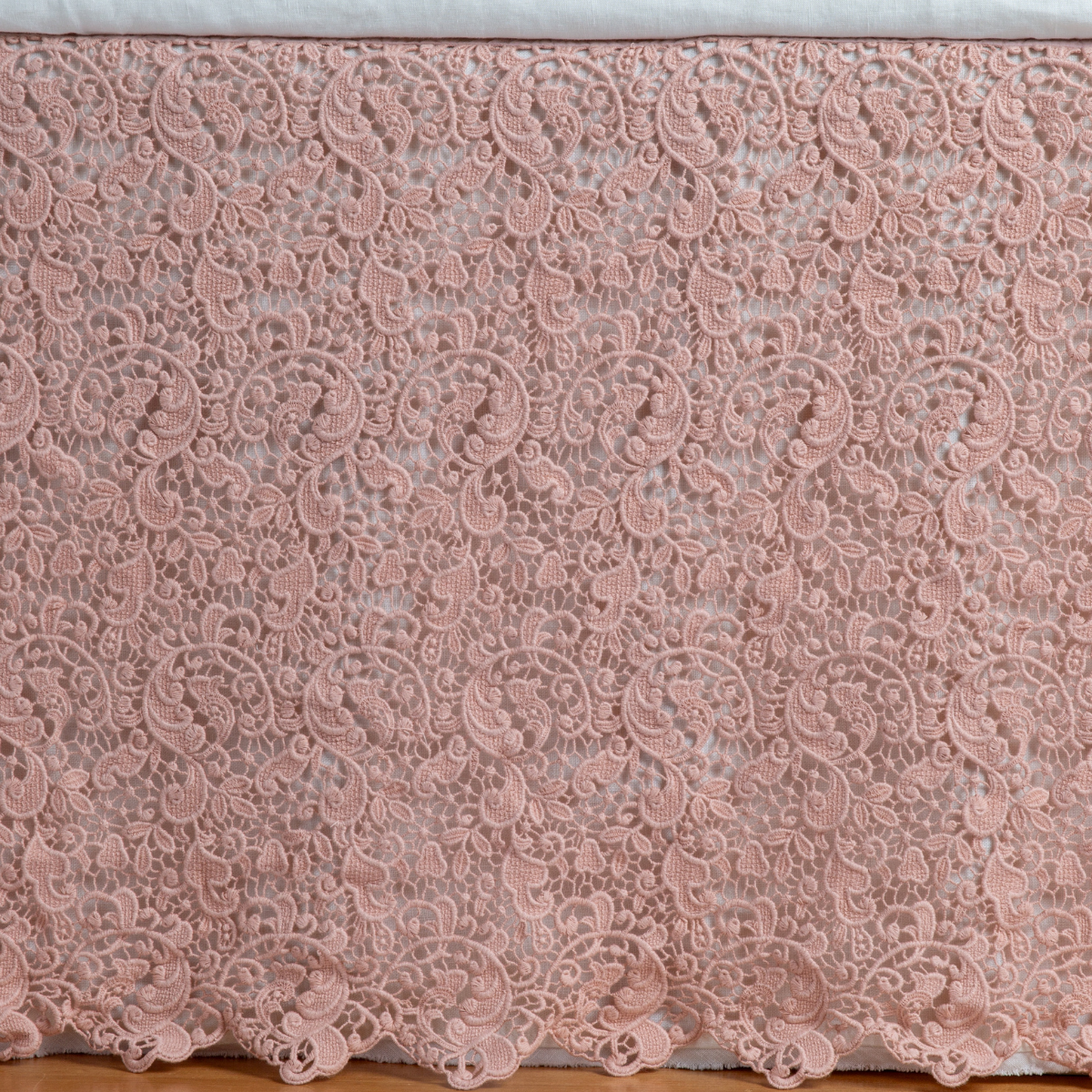 Rouge: a close up of a cotton lace bed skirt layered over a winter white bed skirt - shot straight at the bed skirt. 