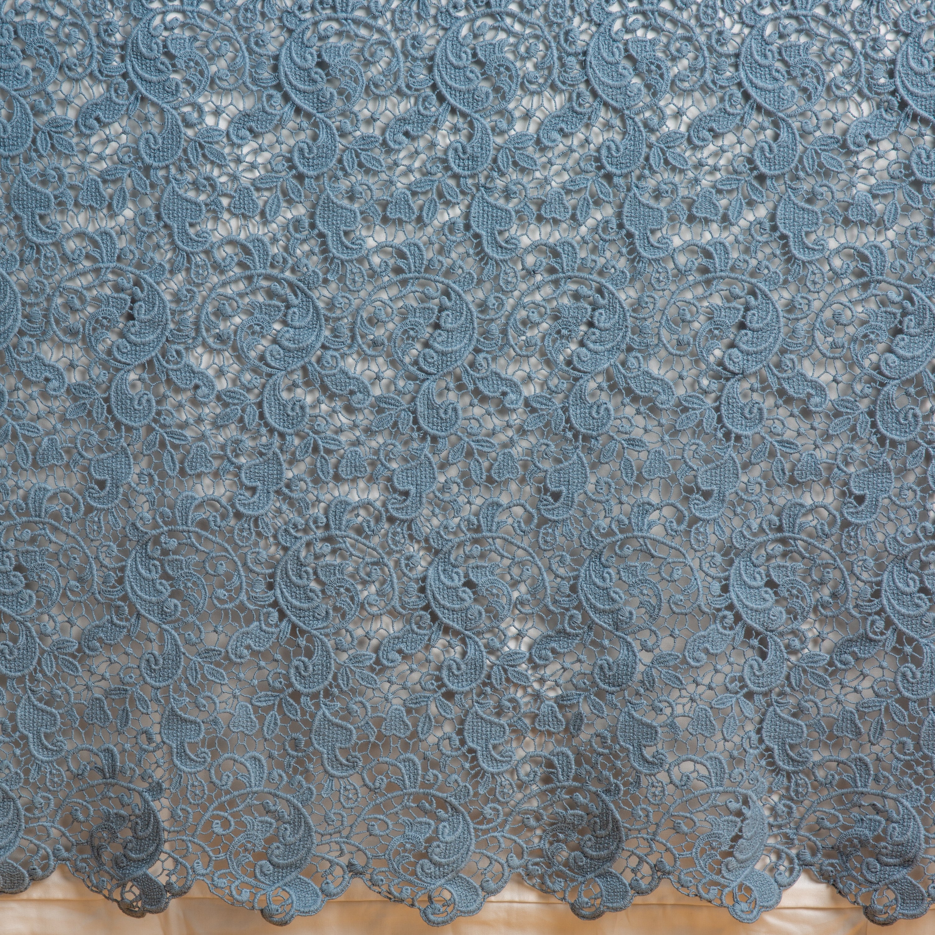 Tahoe Blue: a close up of a cotton lace bed skirt layered over a winter white bed skirt - shot straight at the bed skirt. 