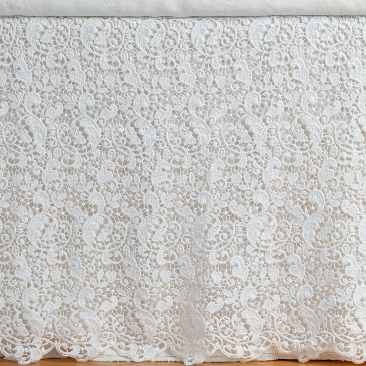 Winter White: a close up of a cotton lace bed skirt layered over a winter white bed skirt - shot straight at the bed skirt. 