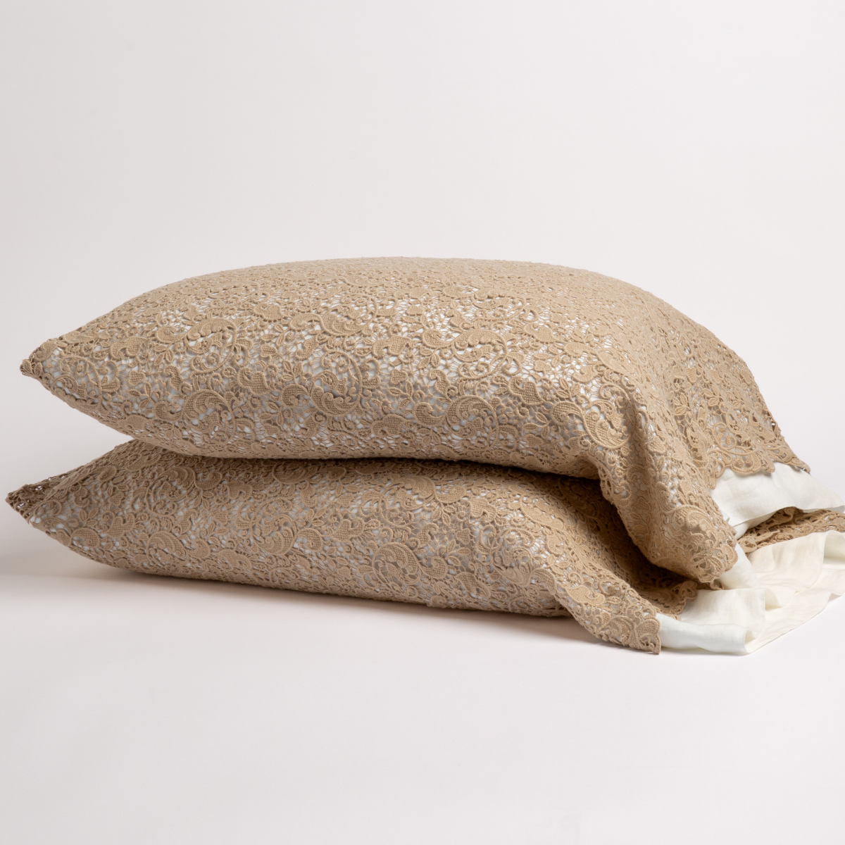 Honeycomb: a pair of stacked cotton lace pillowcase covers on winter white liners against a white background. 