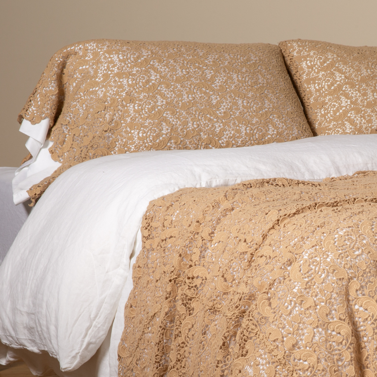Honeycomb: a pair of cotton lace pillowcase covers on winter white liners shown on a bed dressed in winter white linen with a matching cotton lace bed scarf. 