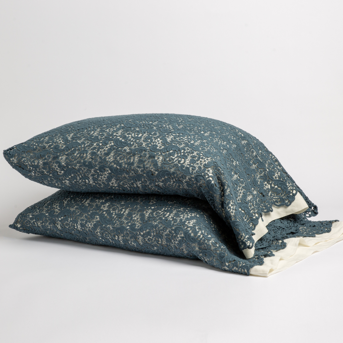 Midnight: a pair of stacked cotton lace pillowcase covers on winter white liners against a white background. 