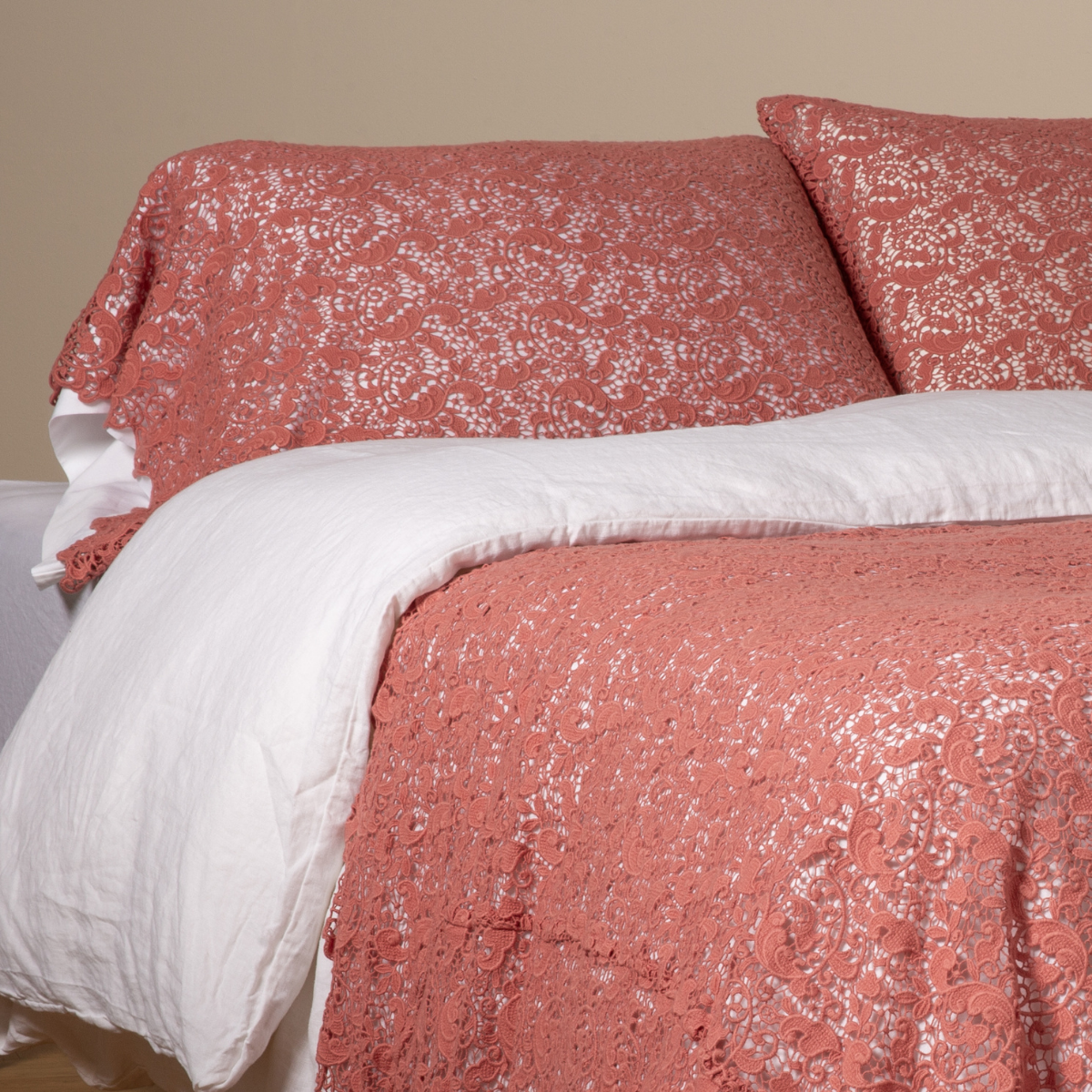 Poppy: a pair of cotton lace pillowcase covers on winter white liners shown on a bed dressed in winter white linen with a matching cotton lace bed scarf. 