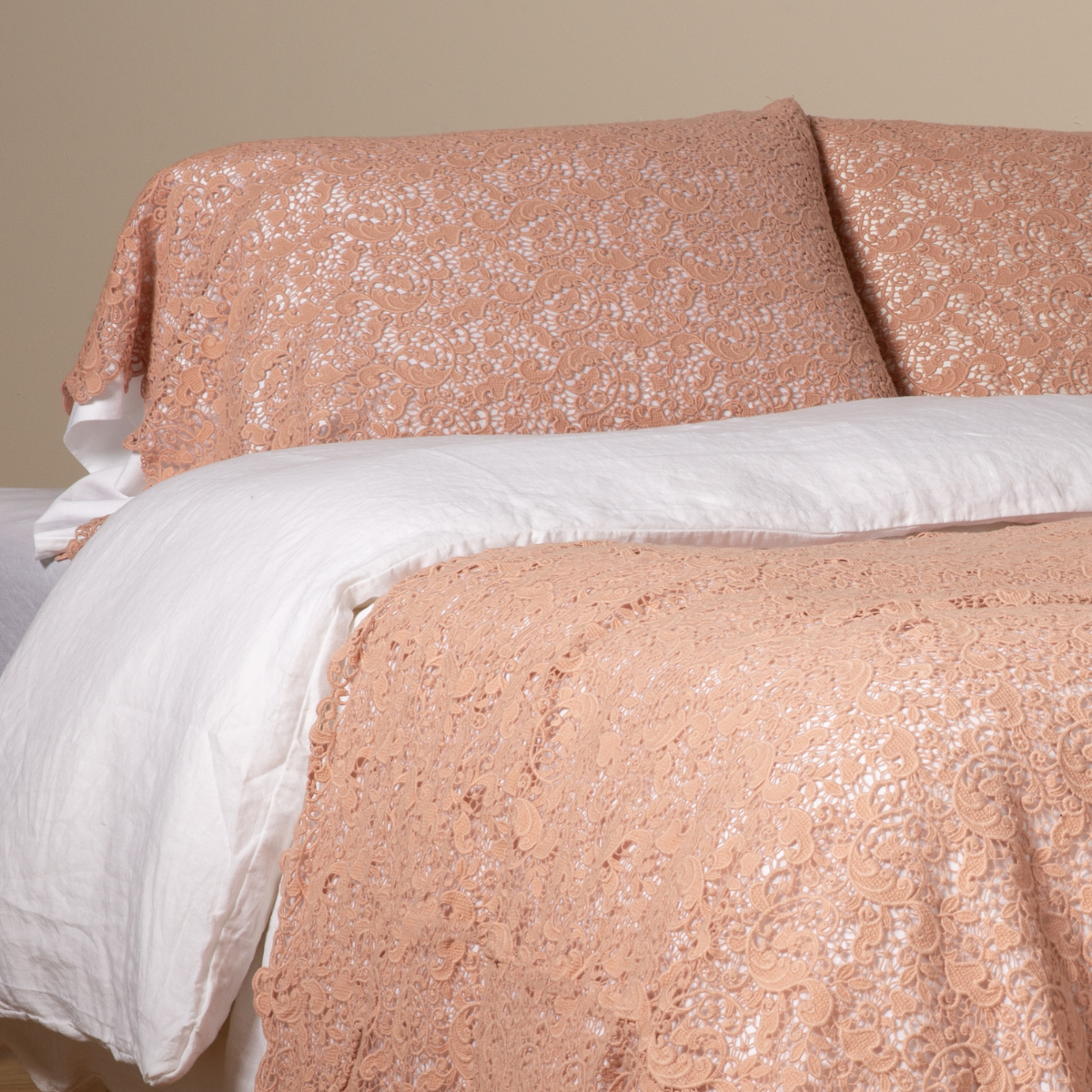 Rouge: a pair of cotton lace pillowcase covers on winter white liners shown on a bed dressed in winter white linen with a matching cotton lace bed scarf. 