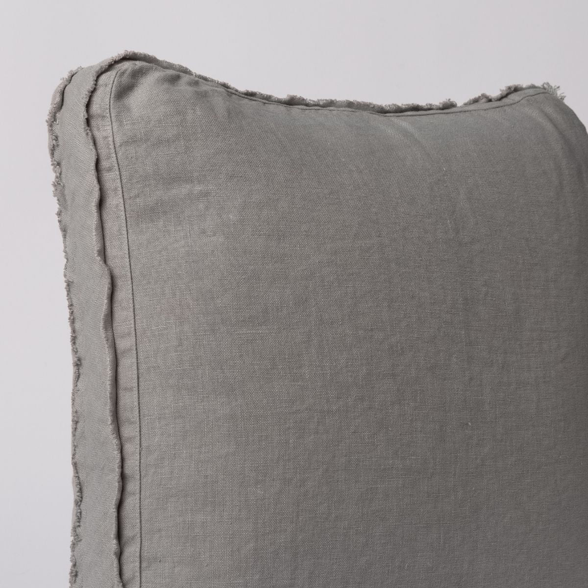 : corner of the throw pillow showing the raw edge detail on the pillows' gusset. 