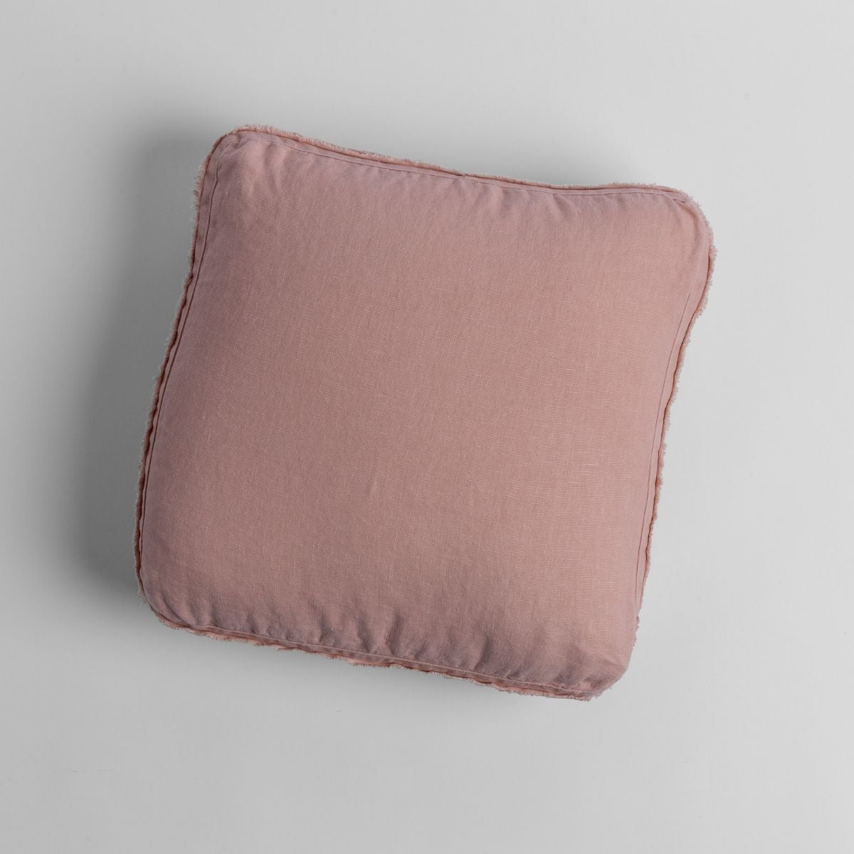 Rouge: midweight linen 18x18 inch throw pillow shot from overhead against a white background. 