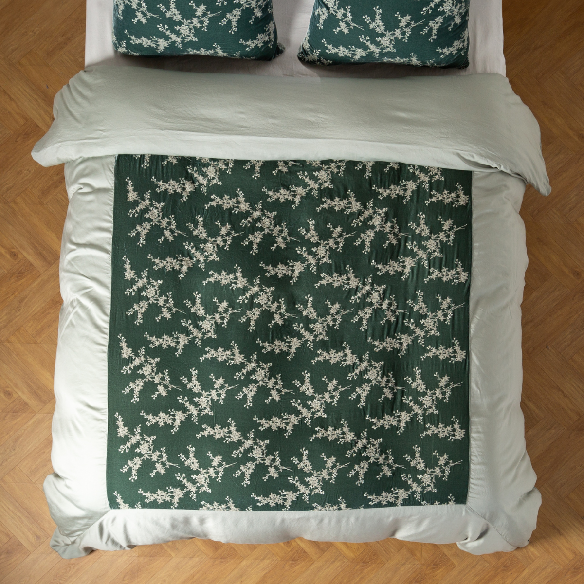 Eucalyptus: An overhead shot of an embroidered silk velvet and tencel duvet cover and matching shams. 