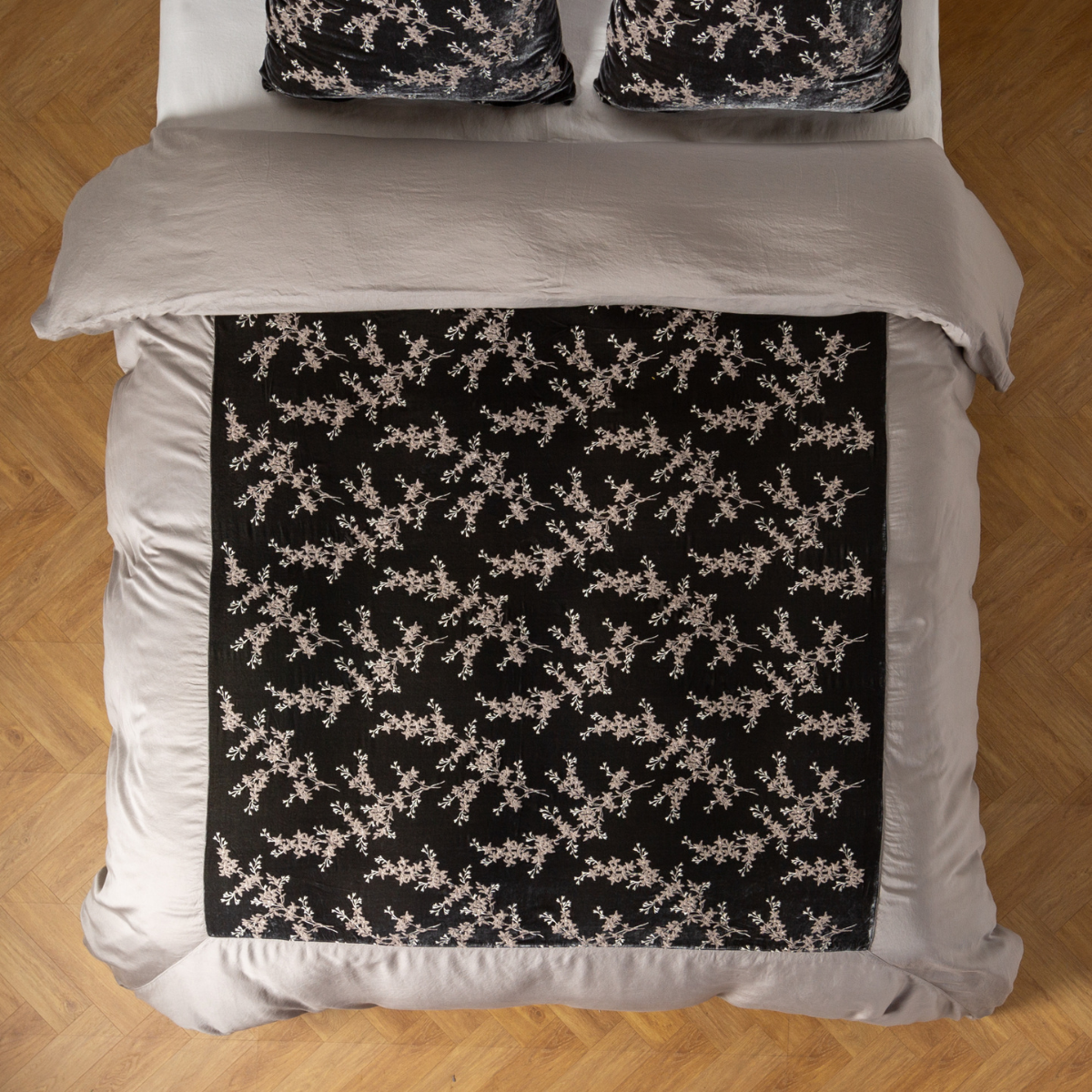 Fog: An overhead shot of an embroidered silk velvet and tencel duvet cover and matching shams. 