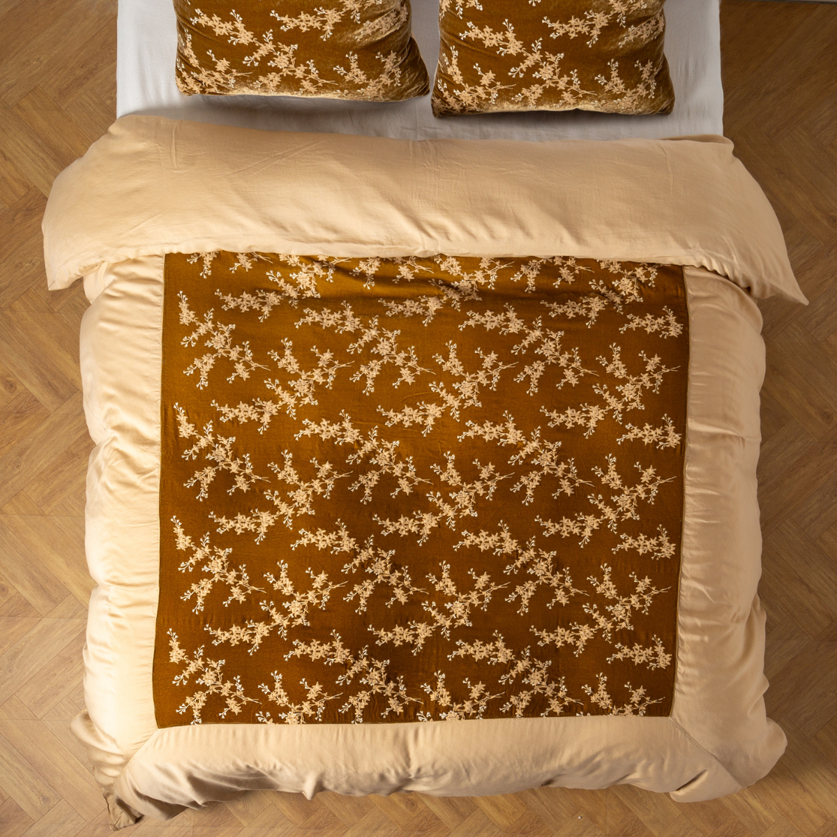 Honeycomb: An overhead shot of an embroidered silk velvet and tencel duvet cover and matching shams. 