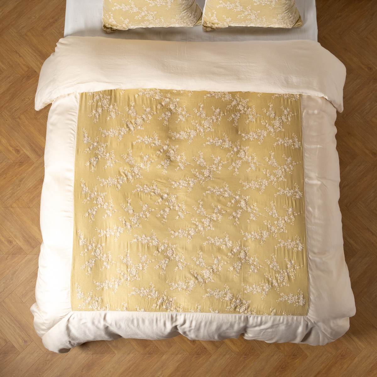Parchment: An overhead shot of an embroidered silk velvet and tencel duvet cover and matching shams. 