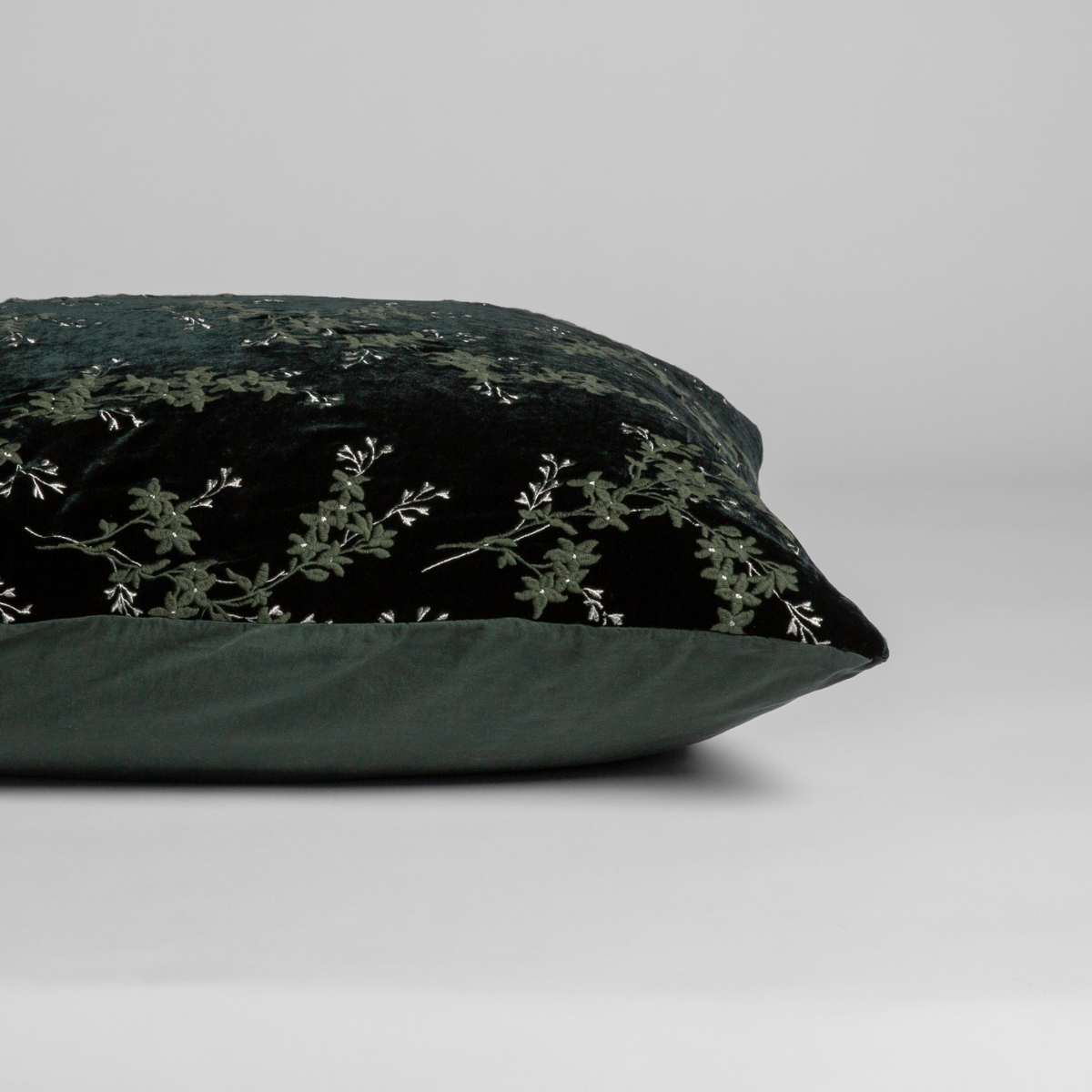 Juniper:  A close-up of the sham shown on its side to display the embroidered silk velvet face and tencel back — shown against a white background. 