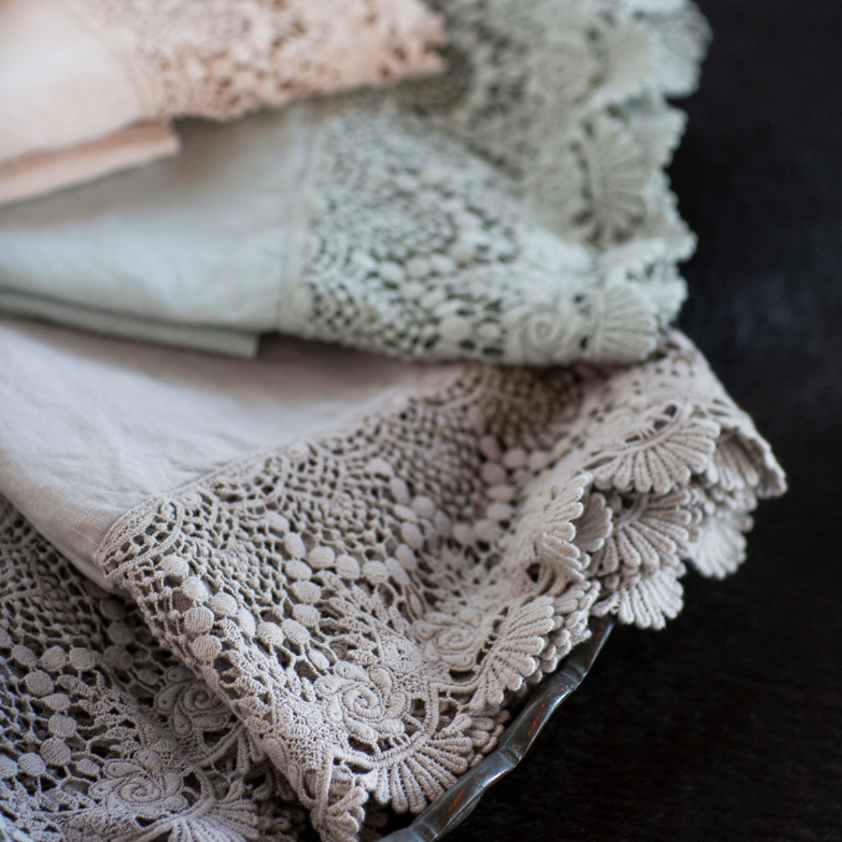 : a close up of the mattine lace trimming linen guest towels. 