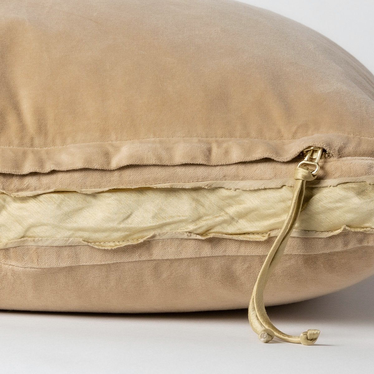 Honeycomb: Close-up of charmeuse gusset, raw-edge trim, and brass zipper detail  on cotton velvet sham - side view.