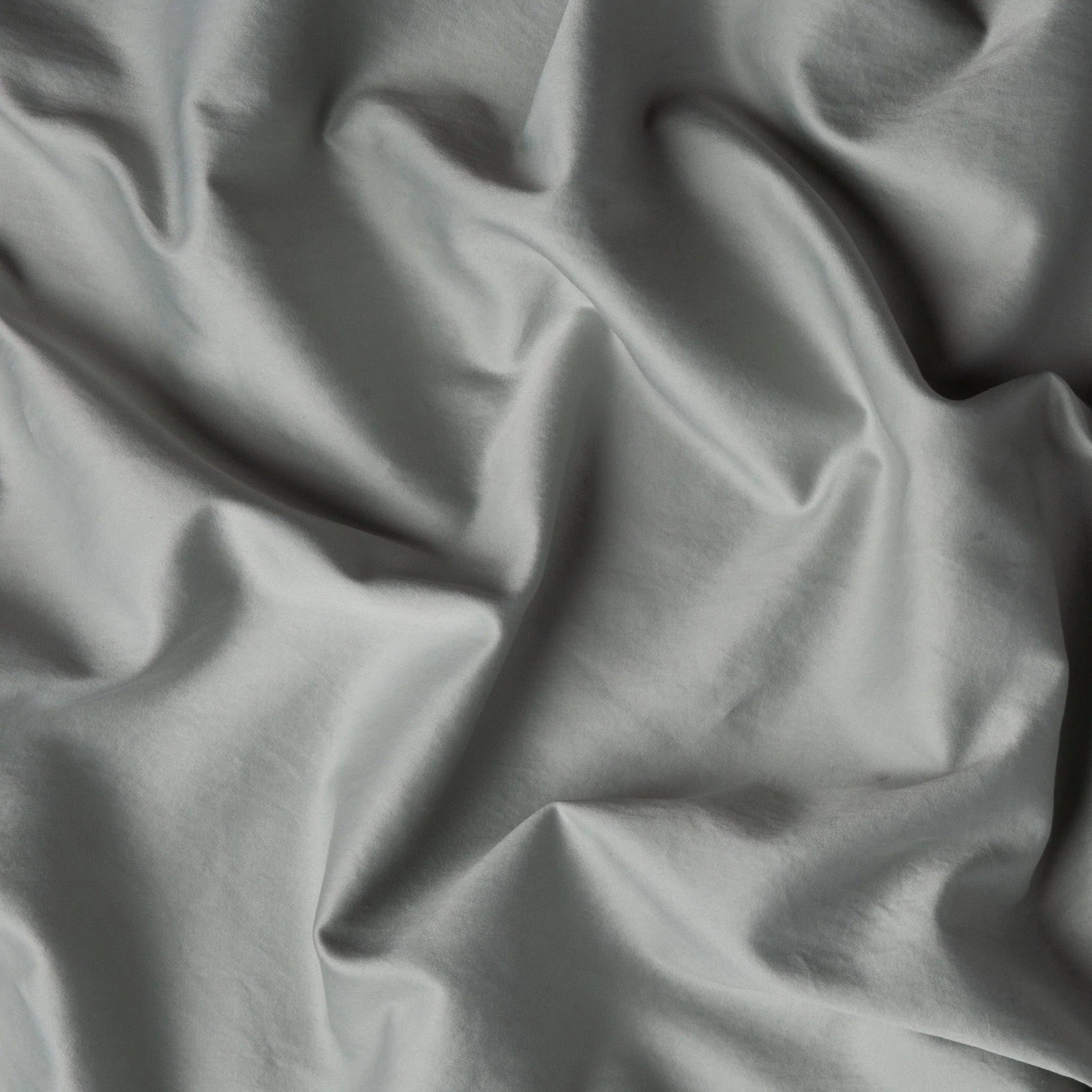 Eucalyptus: A close up of cotton sateen fabric in eucalyptus, a soft light green. 