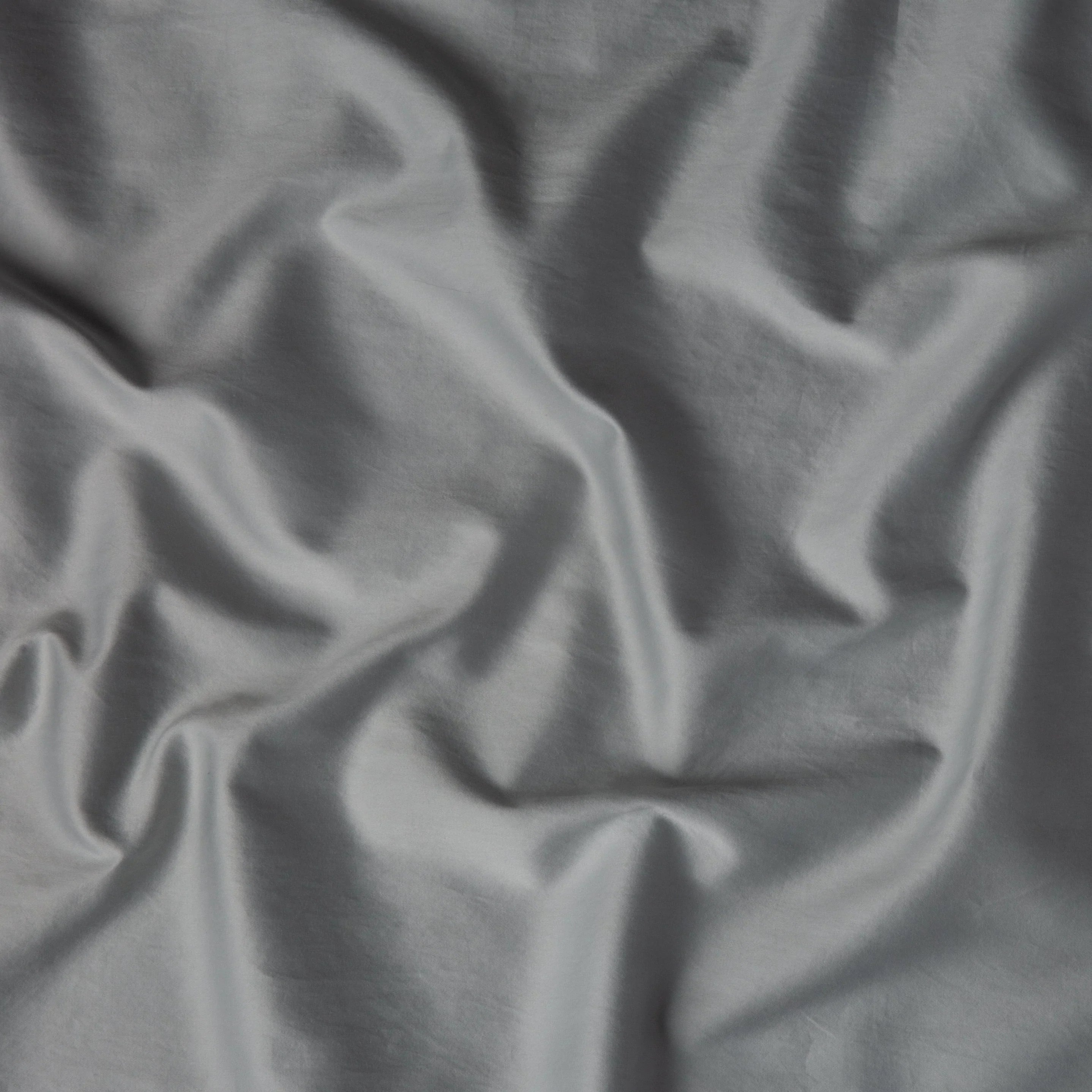 Mineral: A close up of cotton sateen fabric in mineral, a soothing seafoam blue with subtle grey-green undertones. 