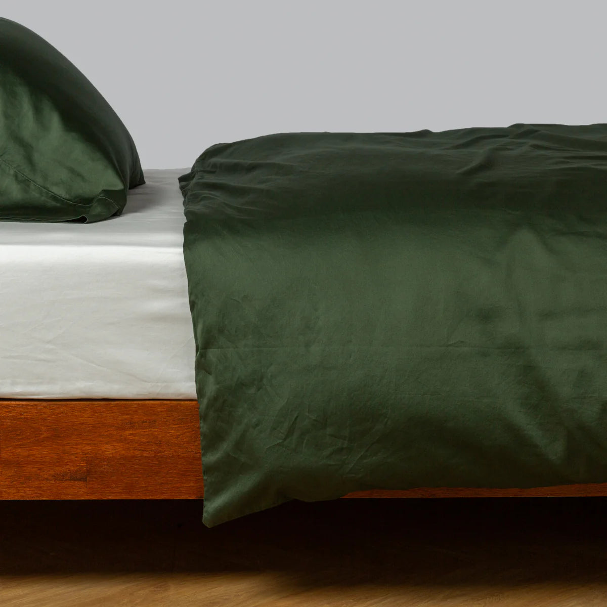 Juniper: duvet cover and matching sleeping pillow on white sheeting - side view.