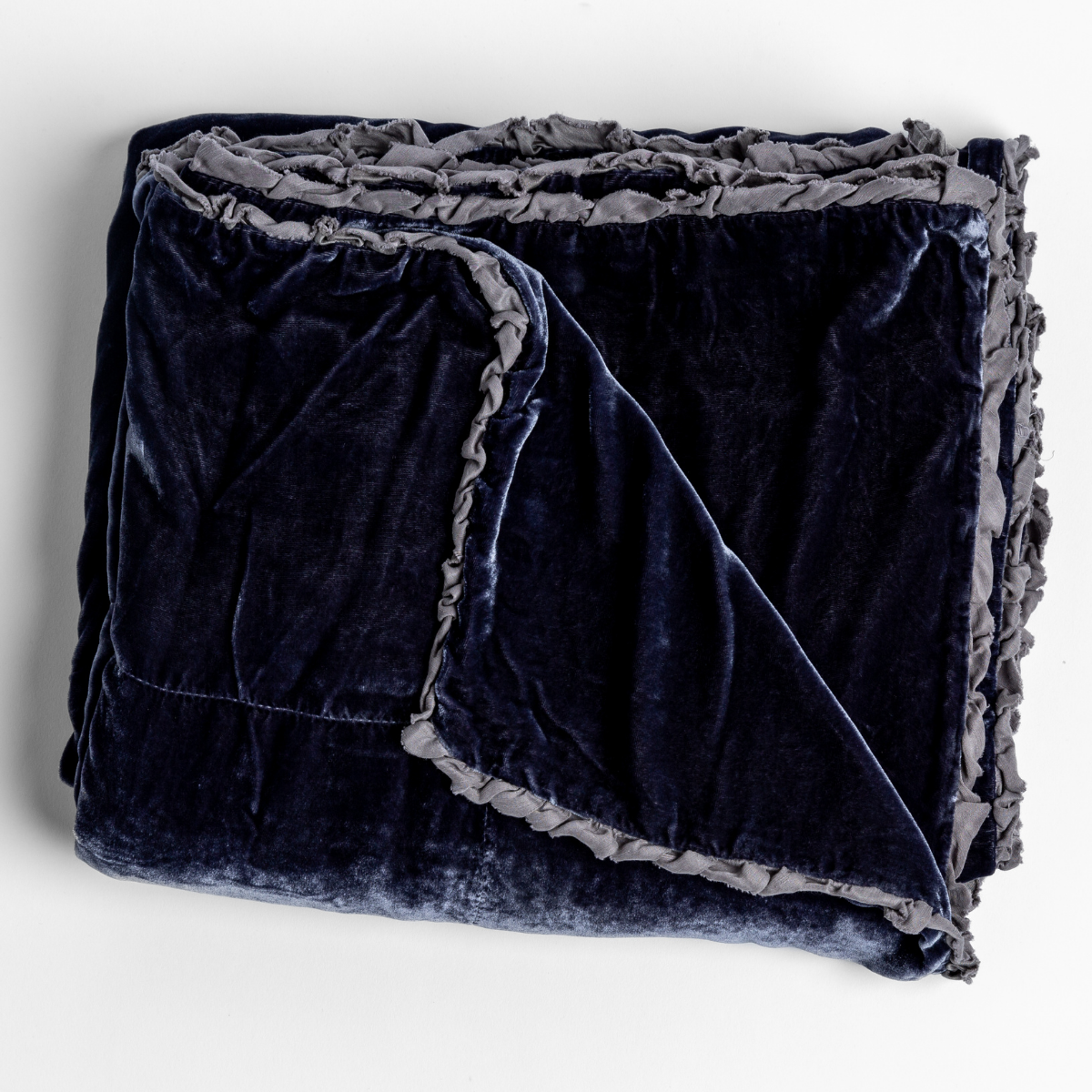 Folded silk velvet blanket with charmeuse trim shown in french lavender, a mature purple tone. 