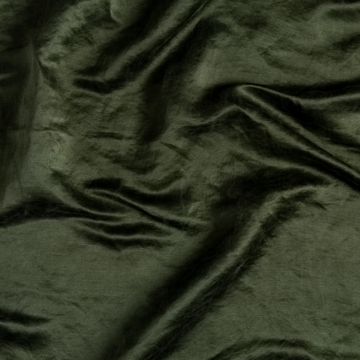 Juniper: A close up of charmeuse fabric in Juniper, a deep green tone.