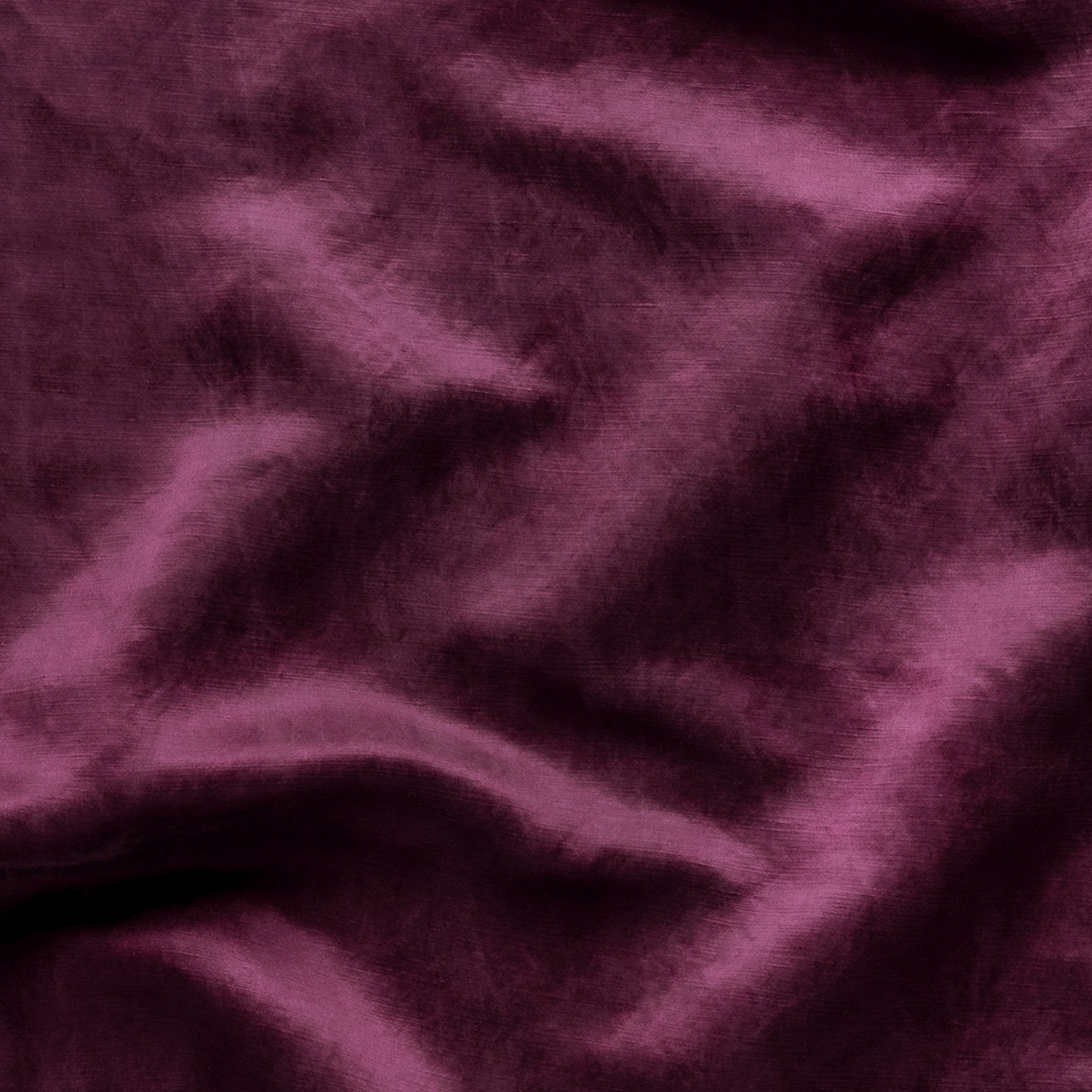Close-up of silk charmeuse in fig, a richly saturated purple-garnet. 