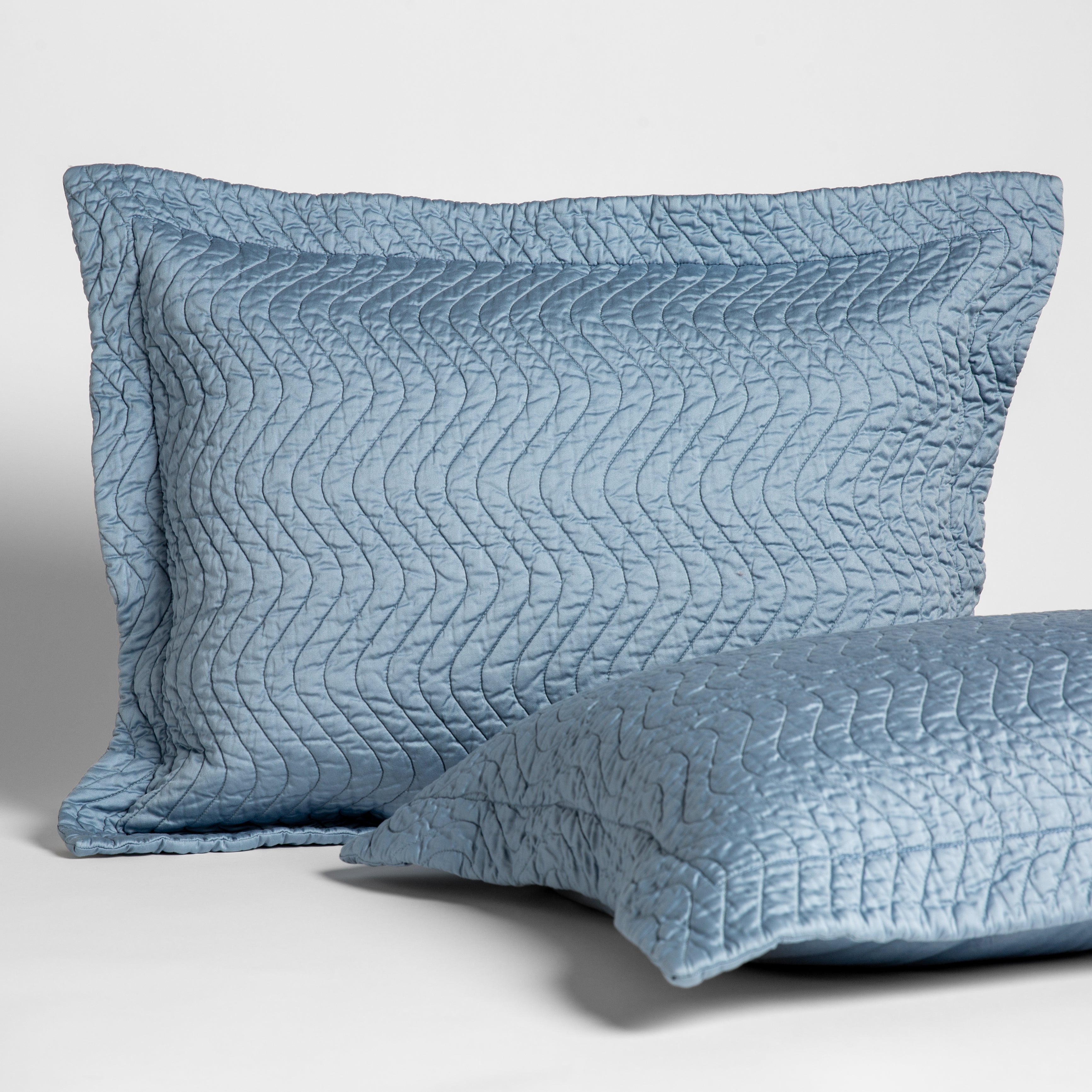 Tahoe Blue: 2 15x24 quilted cotton sateen throw pillows shot overhead against a white background. 