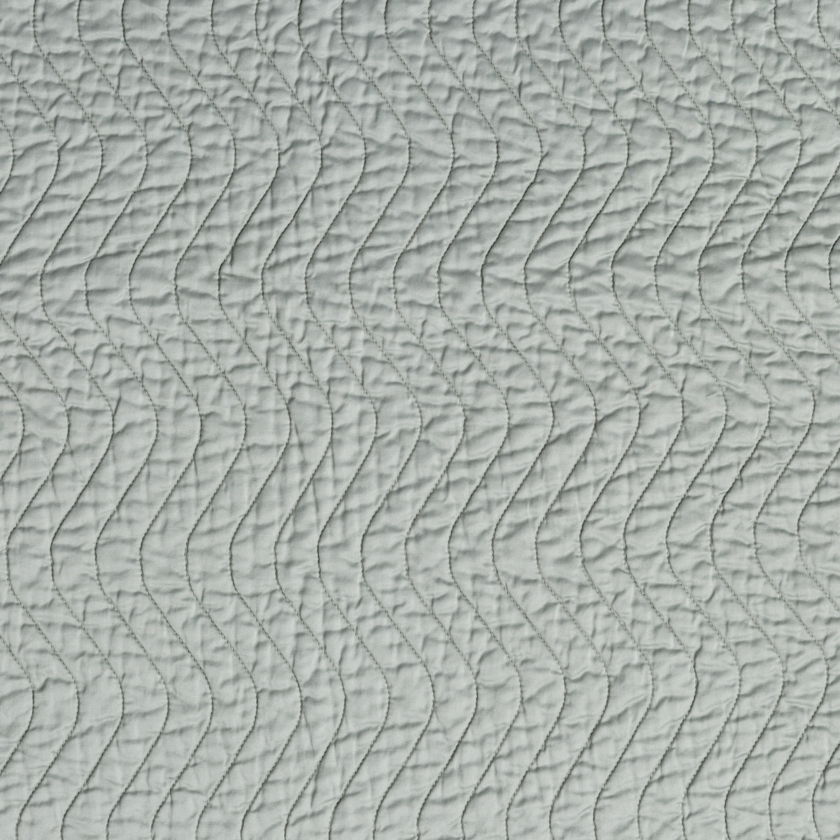 Eucalyptus: A close up of quilted cotton sateen fabric in eucalyptus, a soft light green.