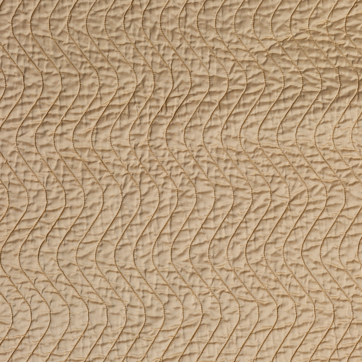 Honeycomb: A close up of quilted cotton sateen fabric in honeycomb, a warm golden tone.