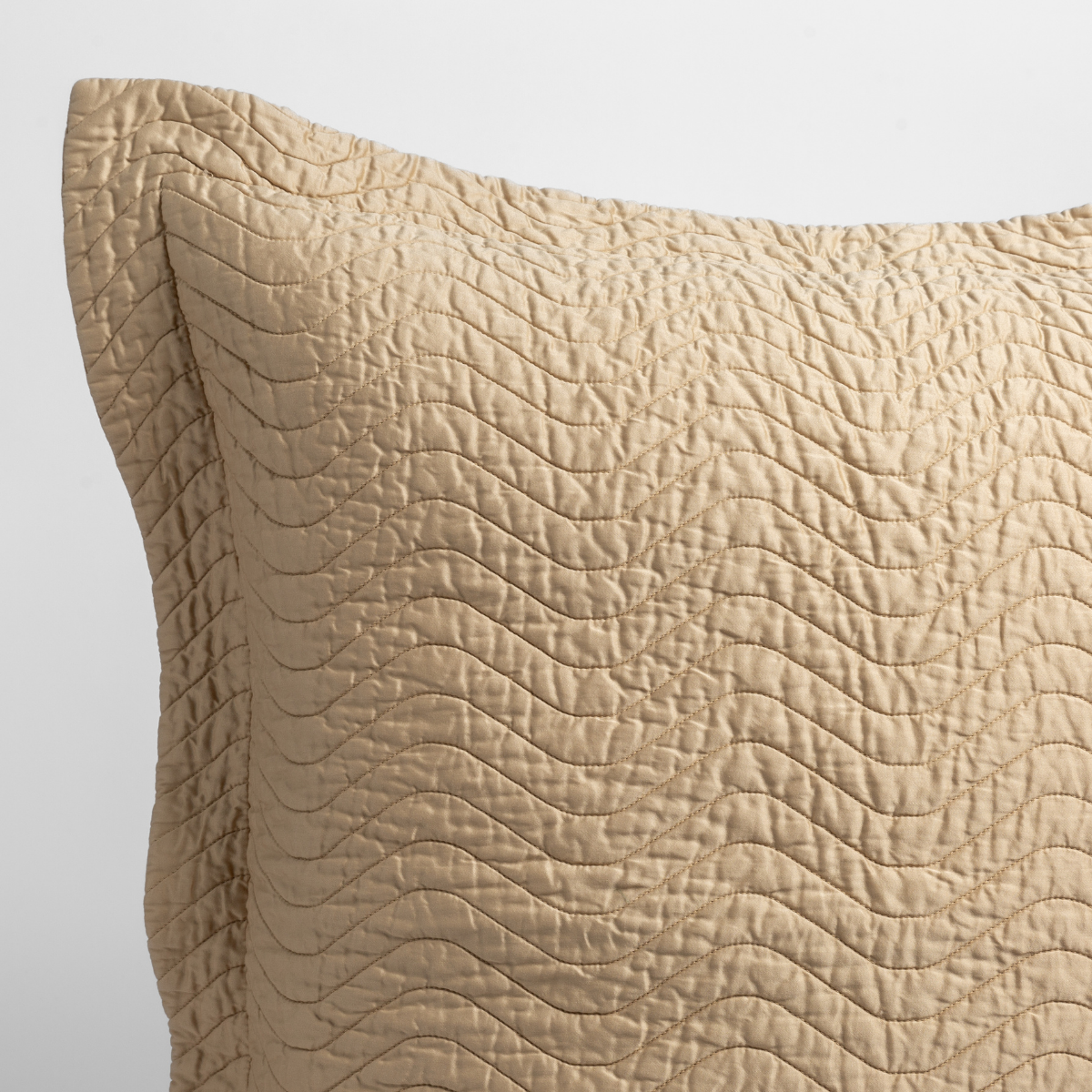Honeycomb: a close up of a pillow corner showing the flange framing quilted cotton sateen shot against a white background. 