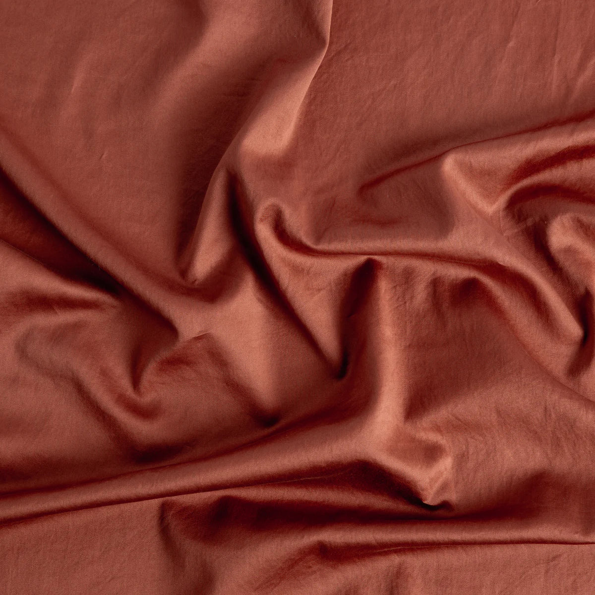 Autumn: A close up of cotton sateen fabric in autumn, a richly saturated persimmon color. 