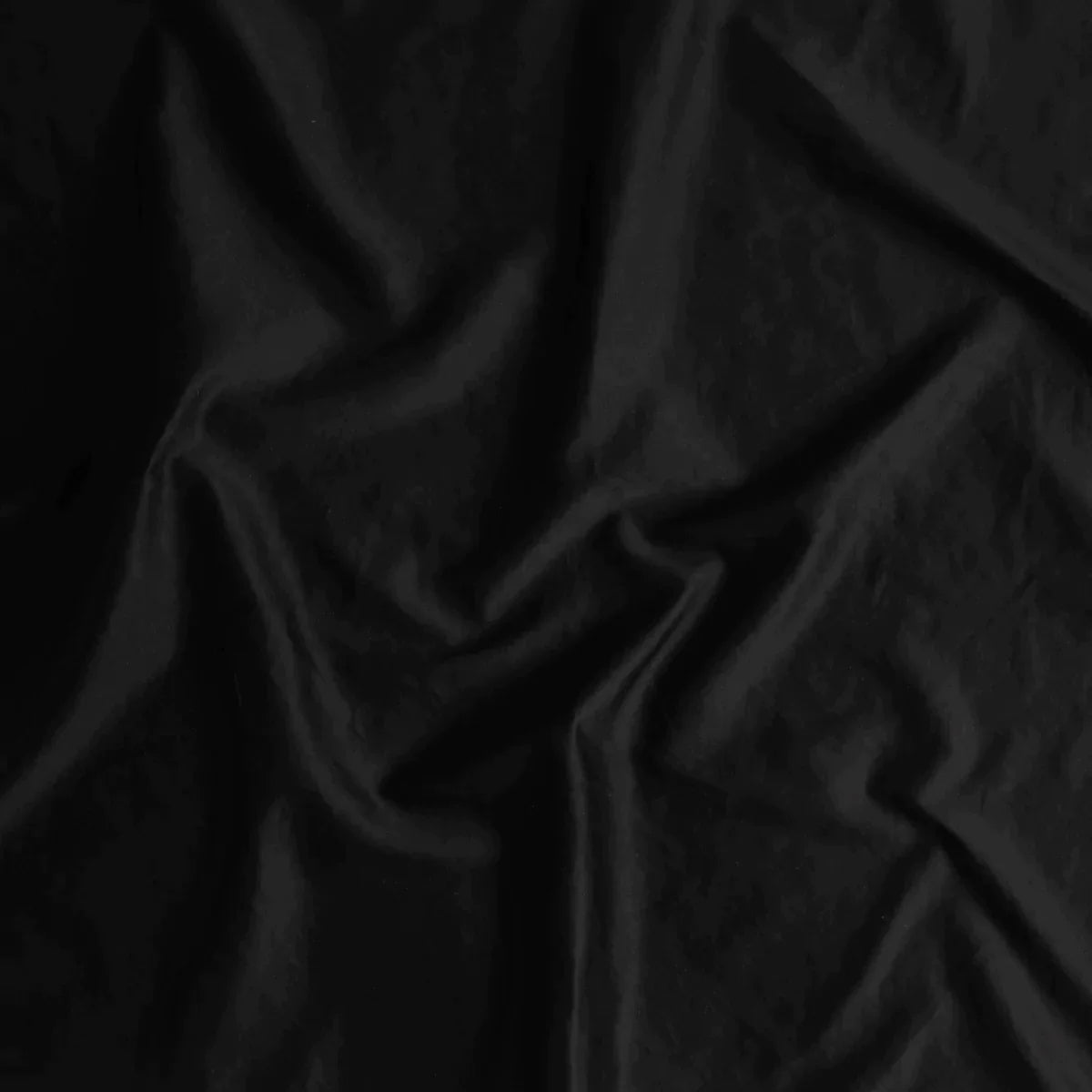 Corvino: A close up of cotton sateen fabric in Corvino, a black tone