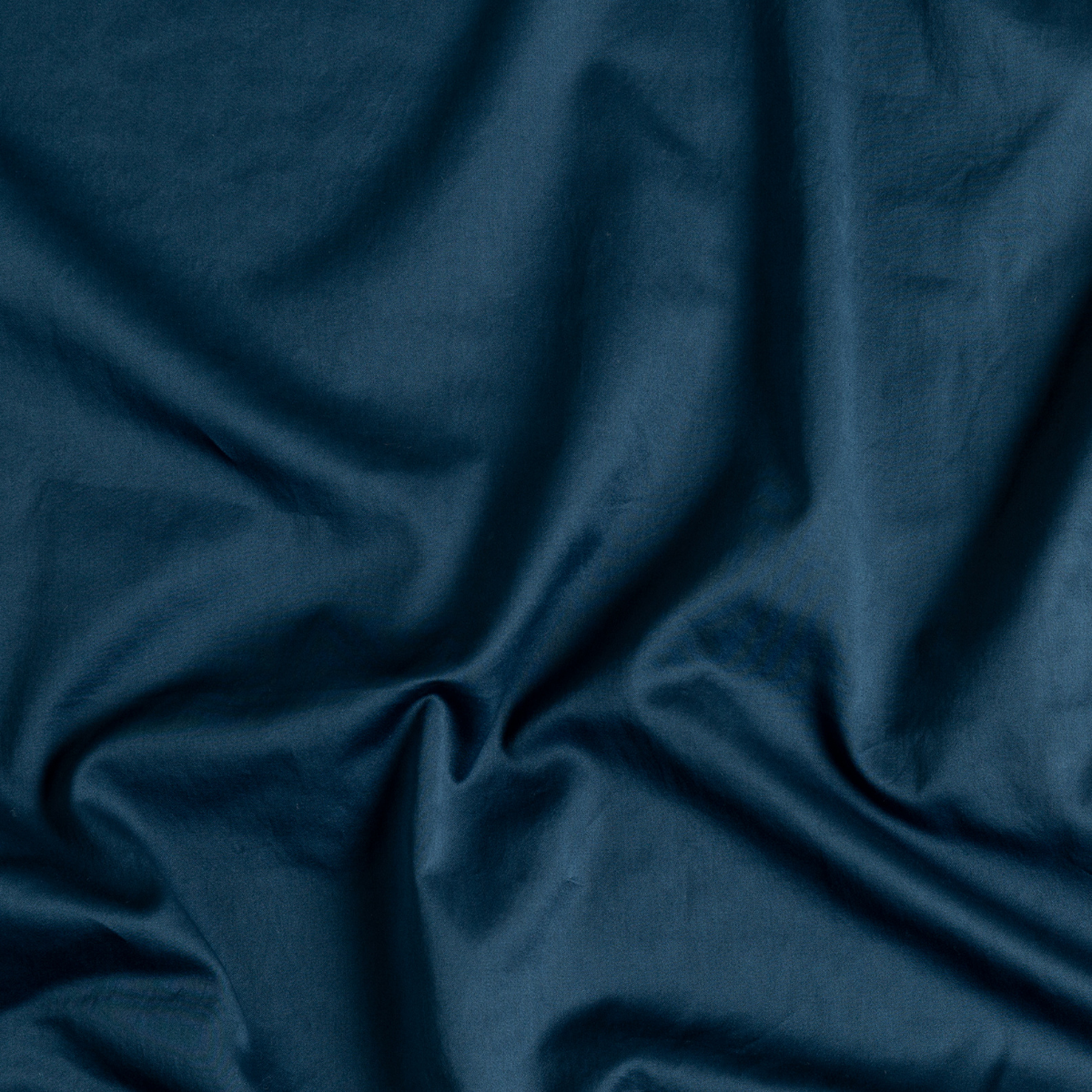 Midnight: A close up of cotton sateen fabric in midnight, a rich indigo tone.