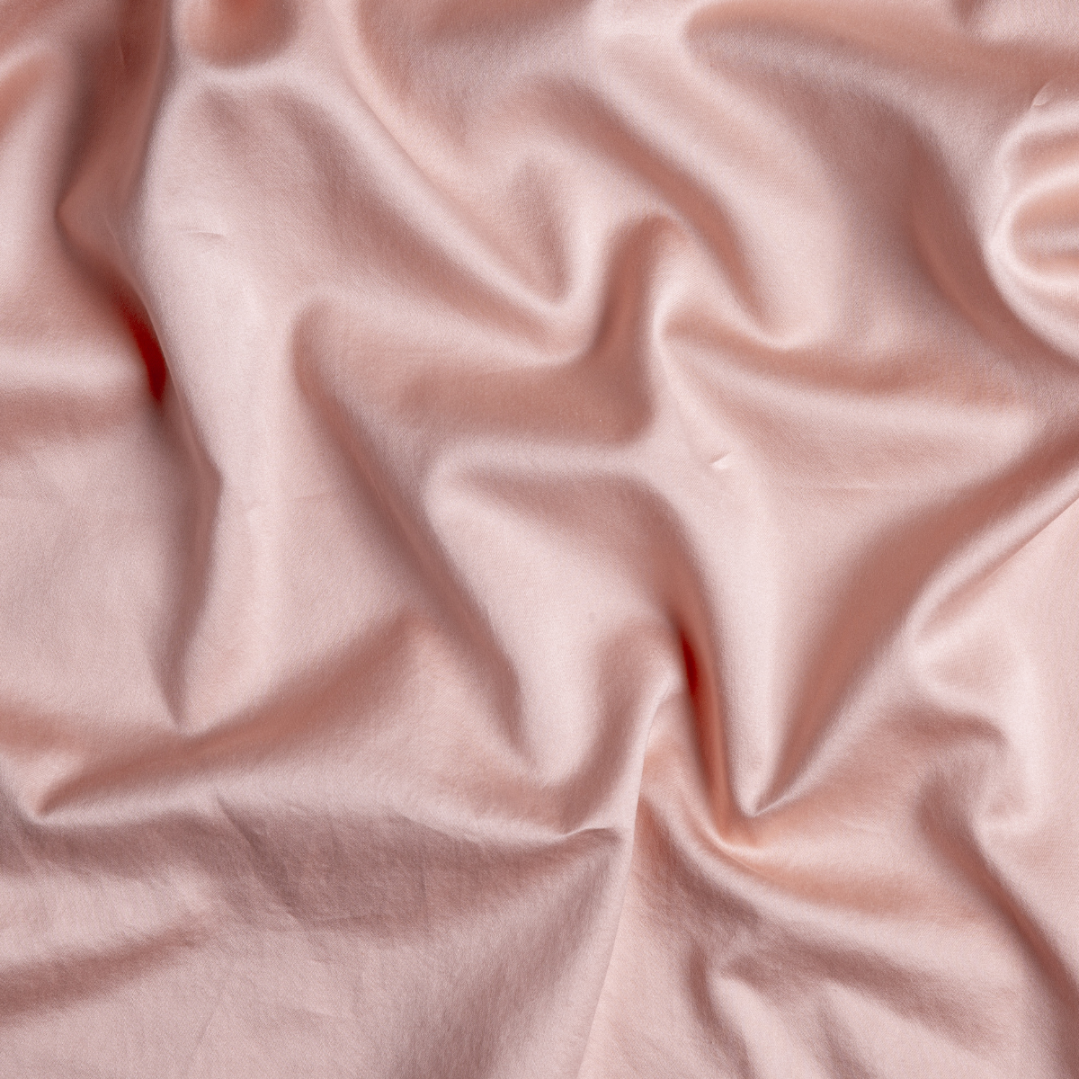 Rouge: A close up of cotton sateen fabric in rouge, a mid-tone blush pink.