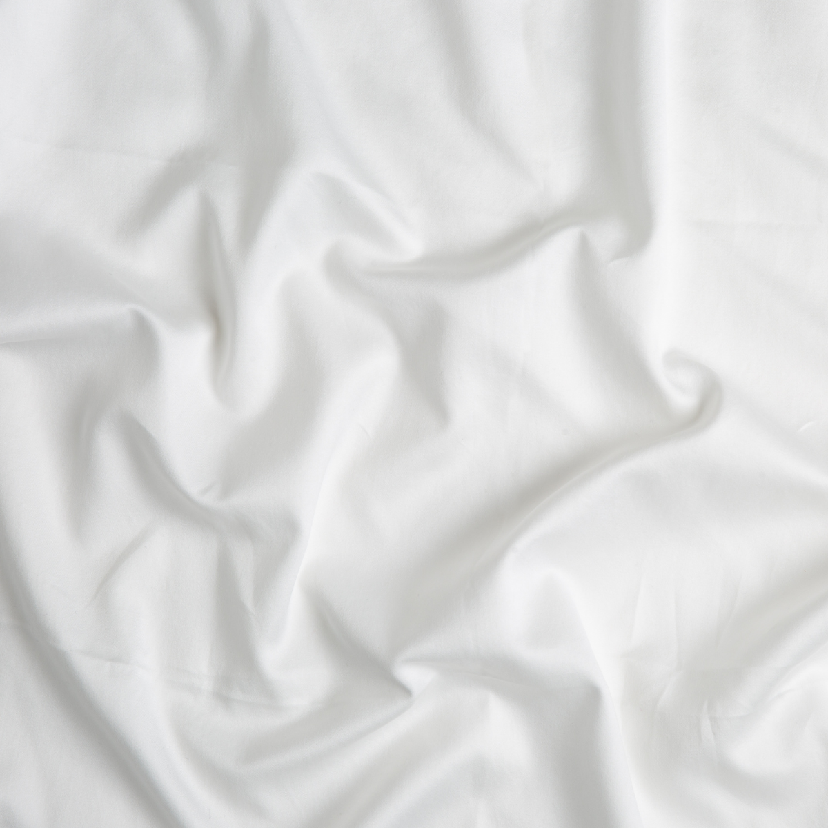 Winter White: A close up of cotton sateen fabric in winter white, softer and warmer in tone than classic white.