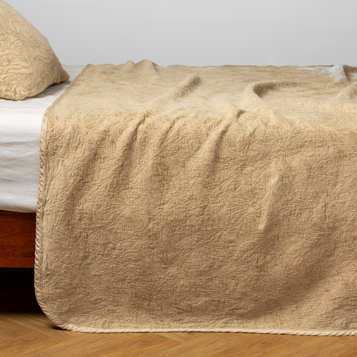 Honeycomb: side view of the chenille jacquard side of a bedspread with the cotton jacquard side showing on the matching sham — shown with a winter white fitted sheet. 