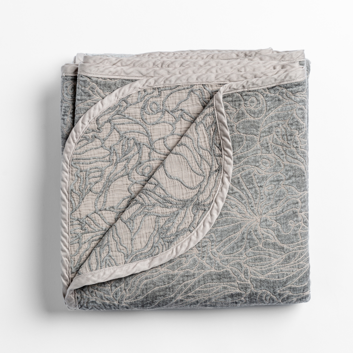 Fog: folded blanket with its cotton jacquard side visible on the corner foldback against the chenille jacquard side. 