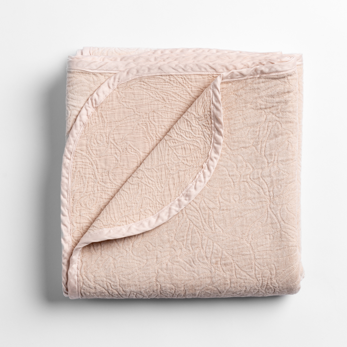 Pearl: folded blanket with its cotton jacquard side visible on the corner foldback against the chenille jacquard side. 