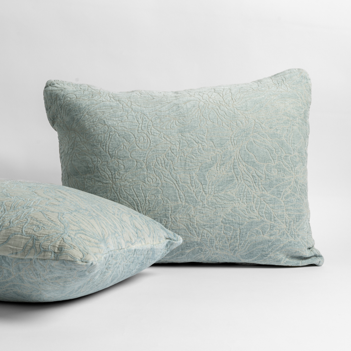 Cloud: pair of shams shown against a white background show the chenille and cotton jacquard faces and floral motif. 