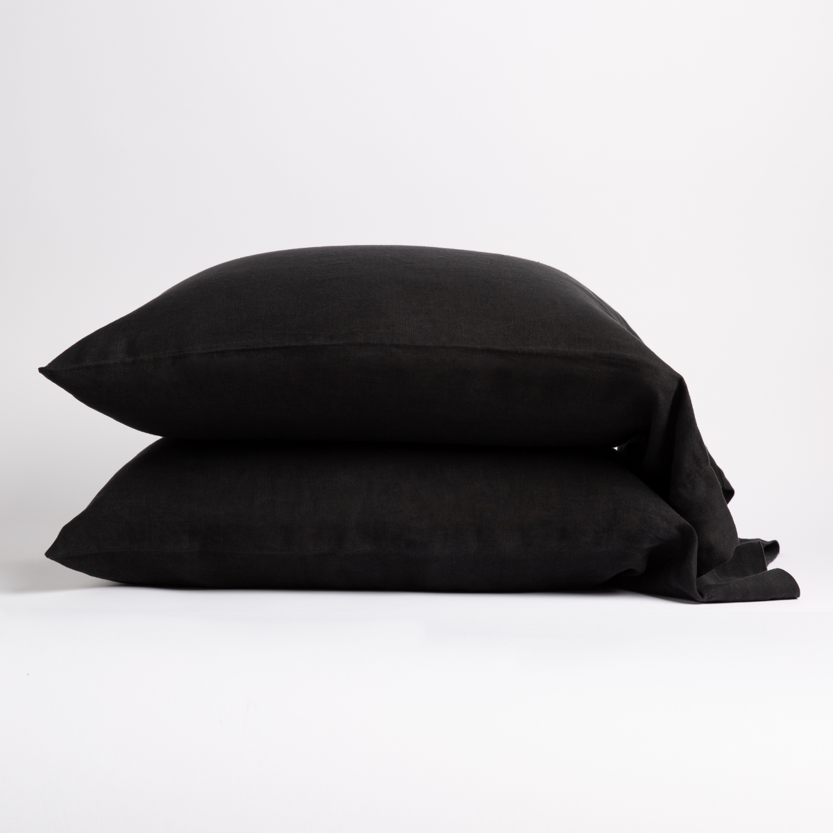 Corvino: Two sleeping pillows neatly stacked against a white background - side view.