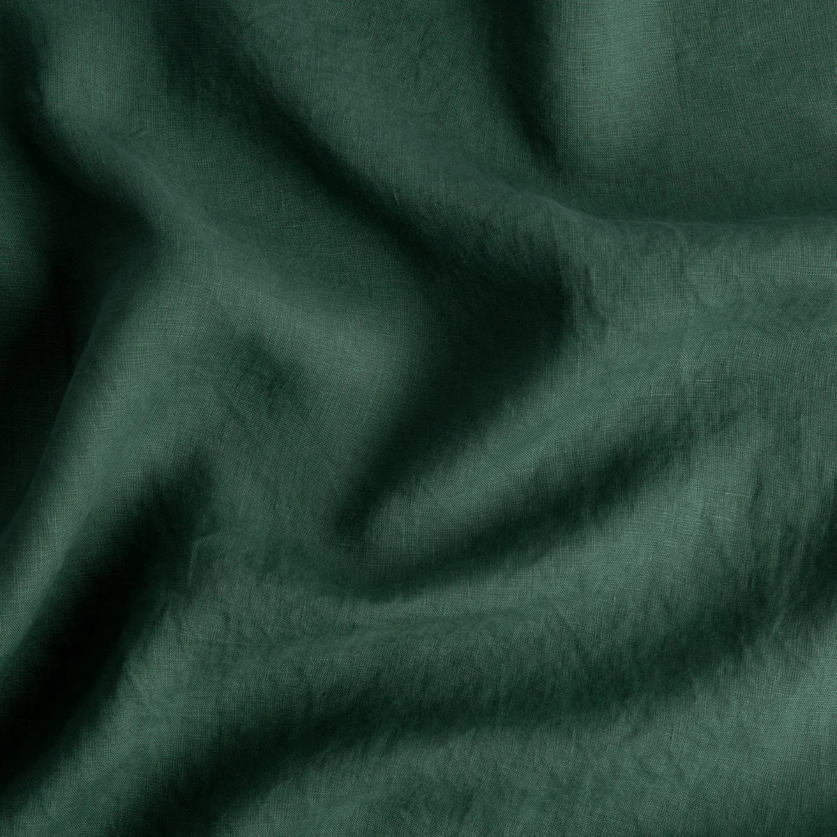 Jade: A close up of linen in jade, a rich, verdant green with subtle blue undertones. 