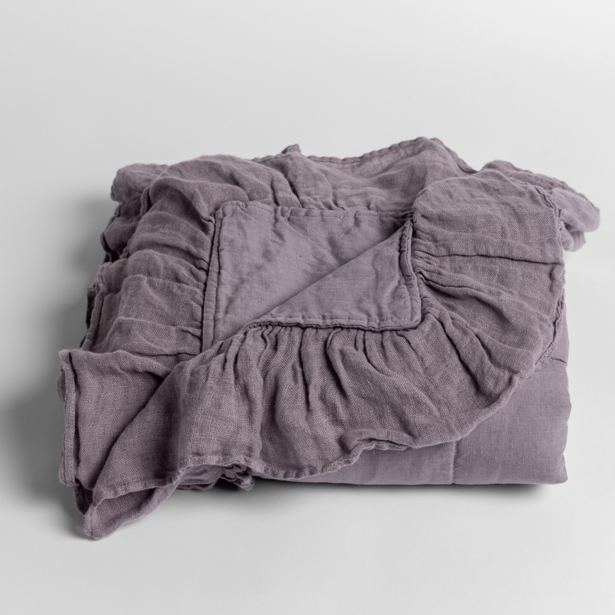 French Lavender: folded baby blanket with a corner folded down showing the whisper-weight ruffle. 