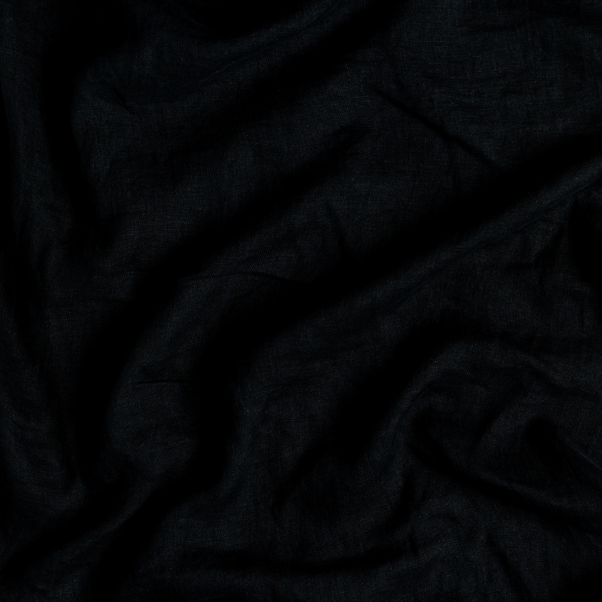 Corvino: A close up of linen whisper fabric in Corvino, a black tone.