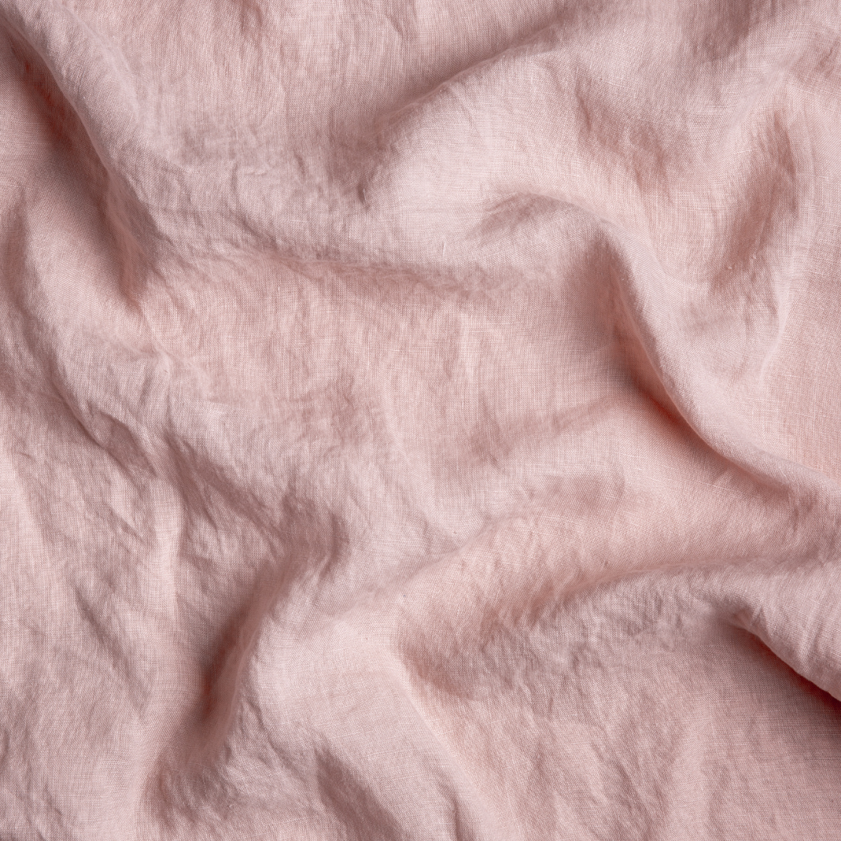 Rouge: A close up of linen fabric in rouge, a mid-tone blush pink.